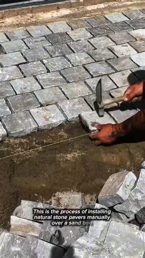 Skilled Craftsman Hand-Laying Natural Stone Cobblestone Pavers | Precision Masonry Installation