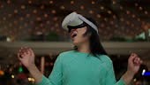 Exciting asian female wearing vr headset getting experience using...