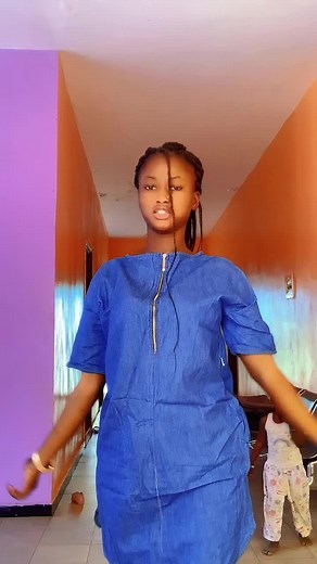 Blue Dress Dance Routine in Colorful Corridor