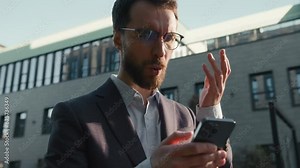 Upset Caucasian man outdoors in city mobile phone failure lost connection stressed businessman read bad news smartphone problem outside frustrated business guy office employer worried trouble in town