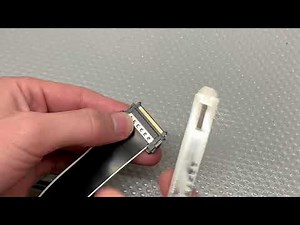 Removing the Qidi extruder ribbon cable connector.