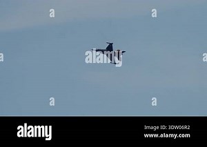 LUQA, MALTA - SEPTEMBER 28, 2025: Dynamic video of an F-16 fighter jet performing a high-speed aerobatic maneuver. The aircraft banks and turns before flying directly towards the camera in a thrilling low-angle shot.
