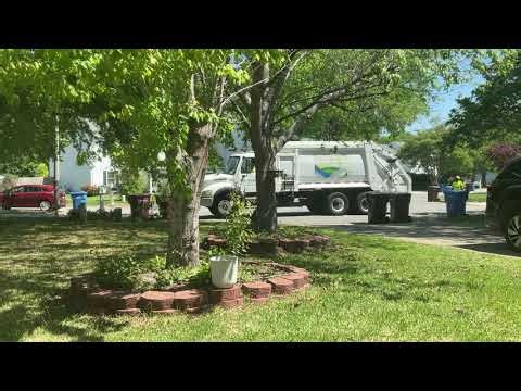 Freghtliner M2 Rear Loader Picking Up Buckets And Leaf Bags
