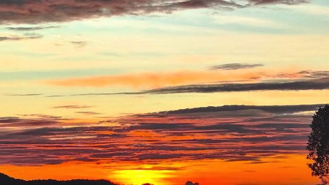 Fiery sunrise glows above rural homes in the Philippines