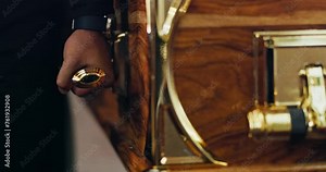 Pallbearer, hands or carrying a coffin at funeral, mourning or dead loved one at remembrance ceremony. Death, sadness or person at service with wooden casket, sad or respect or grief for loss of life