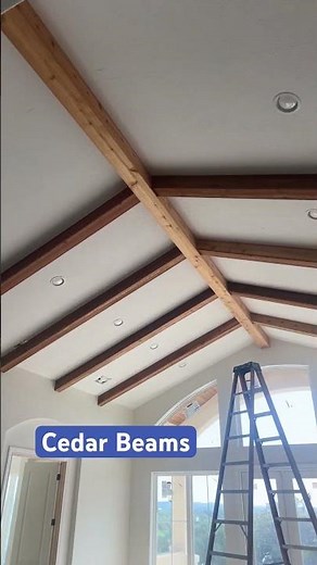 Installing interior cedar beams on the ceiling in this Living Room.