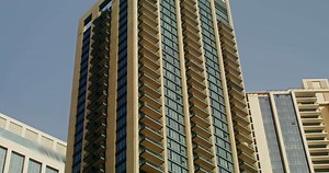 from a car window, a view of the windows of modern skyscrapers of a densely populated city
