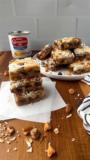 Carnation Milks on Instagram: "These magic bars are the perfect blend of crunchy, sweet, and salty and are SO easy to bake! 🪄🥰 You need: 2c graham cracker crumbs (about 14 graham rectangles) ½ c unsalted butter, melted 1 14oz can Carnation Sweetened Condensed Milk 1c Toll House semi-sweet morsels 1c Toll House butterscotch morsels 1c chopped pecans 1c shredded sweetened coconut Optional- flaky sea salt How to make magic cookie bars 1. Preheat the oven to 350 degrees. Spray a 9x13-inch pan with
