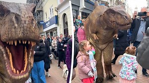 Dinosaur mascot startles crowd with playful roar on busy England street