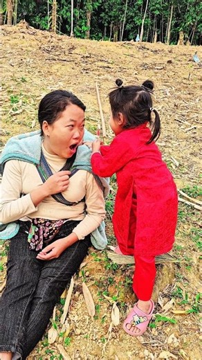 The little girl and her single mother eat candy with the baby.