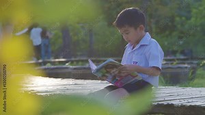 Little kindergarten asian boy enjoy play swing bar outdoor playground happy time kid exercise