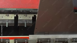 Metal bending, aluminum bending. The technician bends the metal piece he is holding on the bending machine.