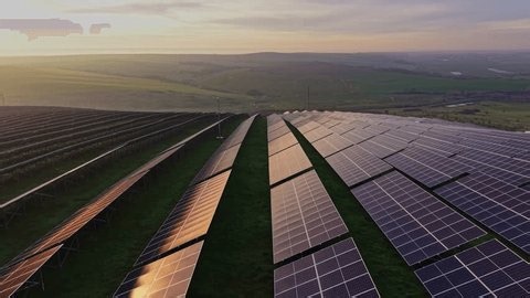 clip-4016131343-solar-energy-panels-lined-on-hillside-sun