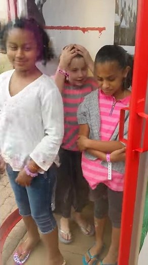 Kids withstanding hurricane wind machine