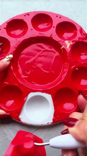 Glossy red paint fills palette wells