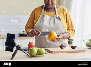 Cropped shot of young black woman cooking healthy meal in kitchen and recording video with smartphone, copy space Stock Photo - Alamy