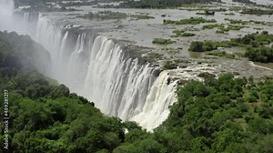 Aerial view Victoria Falls. Beautiful nature of Africa with a waterfall on the Zambezi River with tons of water falling into the gorge.