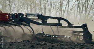 The red chisel plow loosens the soil. The frame is in motion, the camera follows the plow. Agricultural machinery 4K.