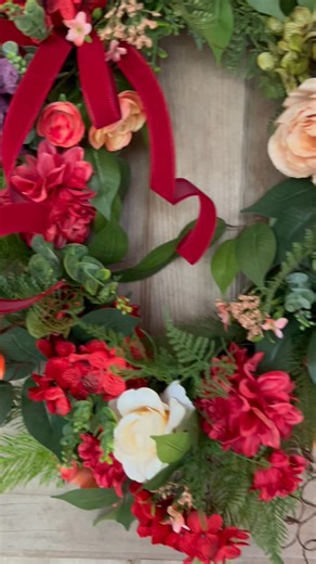 Add a pop of color to your front door! This handmade floral wreath is packed with vibrant red, coral, peach, and purple blooms — finished with a velvet ribbon for an elegant touch. Perfect for spring and summer decorating. One-of-a-kind and ready to ship! #colorfulwreath #hydrangeawreath #everydaywreath | Wreaths by J TX