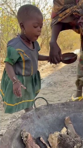 The little girl kept shaking it around but still couldn't get the meat out. #shortvideo #africa