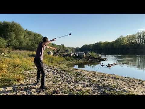 Sling shooting at a target near the river at a distance of 20 meters