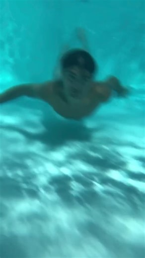 Dynamic Pool Splash: Male Acrobatics in Action