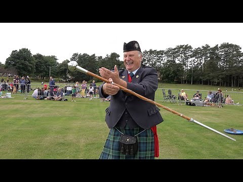 Drum Major Bill Barclay demonstrates the skill of the Mace Flourish during Ballater Games in 2021