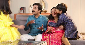 Happy Family sitting on sofa having fun