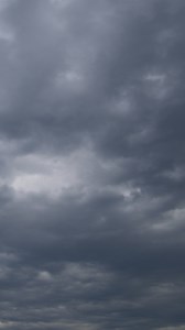 Download Cloudy sky before storm vertical video time lapse on a cloudy day. for free