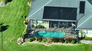 Plastic solar heating panels installed on rooftop of a private house for warming of swimming pool water in cold season. Renewable sun energy used to heat pool