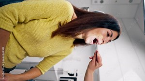 vertical video the ENT doctor examines the patient in the clinic checks the oral and nasal cavity and ear canals with professional instruments