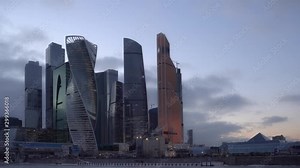 Time Lapse. Day to Night. Financial district of Moscow with futuristic glass skyscrapers. Heavy traffic on the waterfront. Night life of the modern city. HyperLapse. Ultra HD stock footage