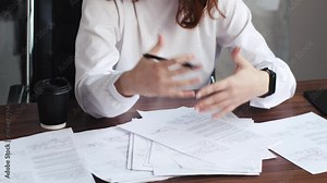 Cropped shot of hands of female financial advisor holding bills while helping clients with estimating expenses and planning budget