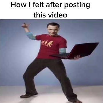 Sheldon Cooper holding a computer while his right hand is up looking like he's about to click it