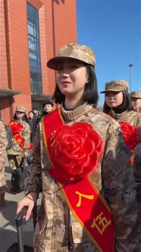 Female recruits gathered at the train station in the spring, awaiting the arrival of their famili...