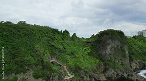 Stunning Nature View Of Cliff Side And Buildings At Oka Point Island In Guam, United States. Pull back aerial
