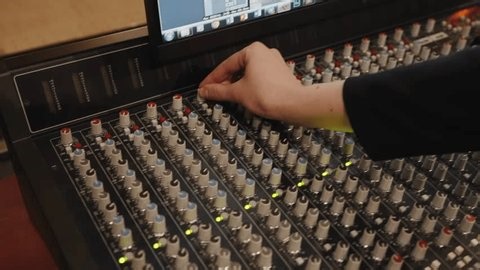 clip-3987949889-studio-control-room-illuminated-meters-tactile-knobs