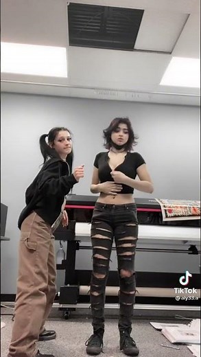 Ladies dancing around. One unzips shirt……a little