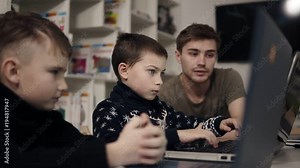 Little boy is trying to type something on laptop keyboard. Learning how to use gadgets. Programming class for kids. Educational process. Stock Video