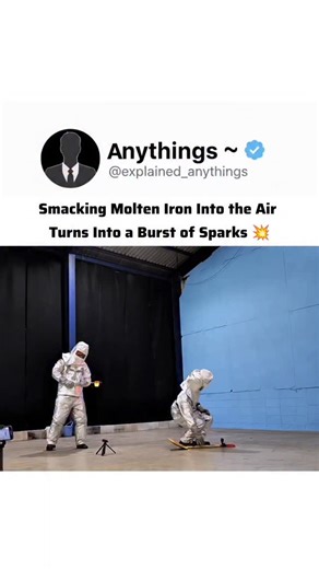 Anythings ~ on Instagram: "In this video, two individuals in aluminized proximity suits (designed to reflect high radiant heat) perform a visually stunning physics demonstration involving molten iron. The Science Behind the "Burst" The dramatic explosion of sparks occurs because of a combination of physical fragmentation and chemical oxidation: Rapid Surface Area Increase: When the person on the right strikes the molten iron with a wooden paddle, the liquid metal is shattered into thousands of t