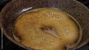 the process of caramelizing pecans in maple syrup to make pumpkin pie