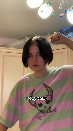 Flexing Arm Muscles in a Colorful Room