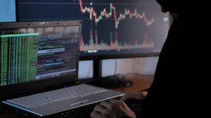 male hacker steals cryptocurrency at night, hacks into exchange and security system, steals token and blockchain data from users. Writes computer code