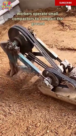 Workers operate small compactors to compact the ground