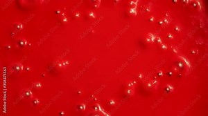 Shooting of red sticky liquid with bubbles, close-up