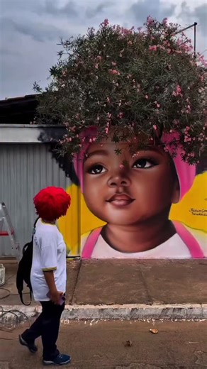 Artistuniversity 🔴 on Instagram: "This street artist takes creativity to another level—painting massive, detailed faces with spray paint across city walls, but leaving the hair unfinished so that the world around it completes the picture. Instead of paint, the “hair” grows naturally from the environment: bushes, trees, or grass sprouting above the wall become part of the art itself. Each mural feels alive, blending human expression with nature in a way that transforms the cityscape into somethi