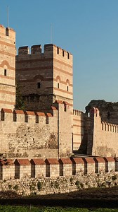 The Walls of Constantinople are a system of defensive stone walls surrounding the historic city of Constantinople, now Istanbul, Turkey. Construction began under Constantine I in the early 4th century AD and continued with major additions during the reign of Theodosius II in the 5th century AD. The most extensive phase, the Theodosian Walls, included a double line of walls and a moat, stretching approximately 5.7 kilometers, or around 3.5 miles, from the Sea of Marmara to the Golden Horn. These 