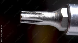 Macro view of spinning torx bit on power drill. Close up view of specialized screw tip, used for assembling furniture or other home diy projects.