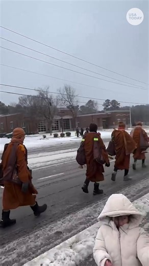 A group of Buddhist monks on the "Walk for Peace" braved the low temperatures and snow as they continued their journey from Fort Worth, Texas, to Washington, D.C. to raise awareness for "peace, kindness and compassion." | USA TODAY
