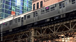 Chicago L passing through downtown loop past a red brick building.